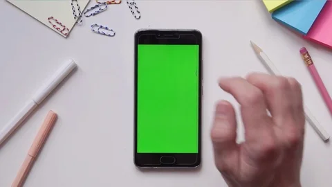 Using Mobile Phone with Green Screen on Designer's Table. Great For Mock-up Usag Stock Footage 74901227