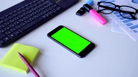 Using Mobile Phone with Green Screen on Designer's Table. Great For Mock-up Stock Footage 118495221