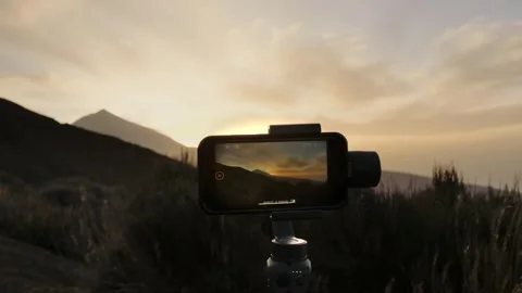 Using mobile phone to make sunset timelapse  against Teide Stock Footage 314547813