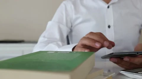 Using mobile phone in office Stock Footage 65211913