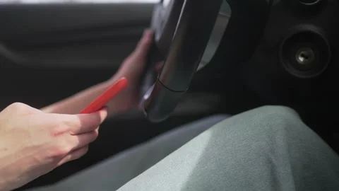 Using a mobile phone in a traffic jam while driving a car. A person writes a Stock Footage 195178091