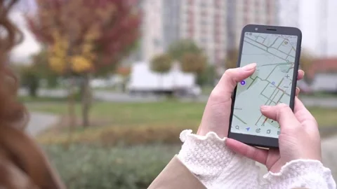 Using mobile smart phone search location on satellite navigation application Stock Footage 163362416