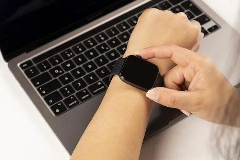Using modern smart watch, close up photo of Caucasian woman hands using watch. Stock Photos