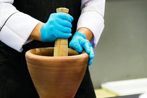 Using a mortar and pestle to pound ingredients for thai food, Pound mortar Stock Photos