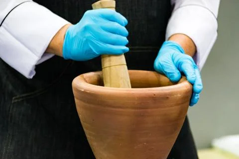 Using a mortar and pestle to pound ingredients for thai food, Pound mortar Stock Photos