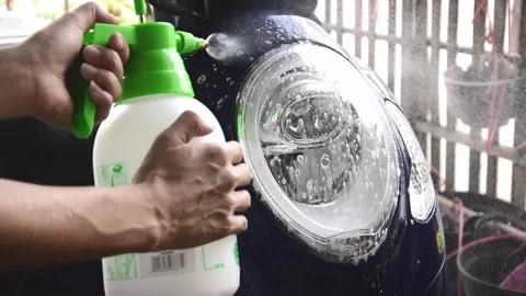 Using motorcycle headlight cleaner, washing motorcycle Stock Footage 303233410