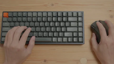 Using a mouse and typing On A Keyboard Stock Footage 254229763