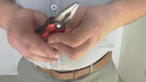 Using a multi purpose tool. Multitool. Stock Footage 77557456