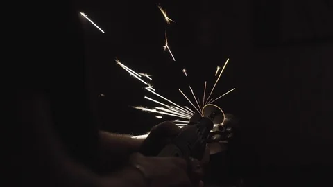 Using a multi tool with sparks in a dark lit room Stock Footage 125445642