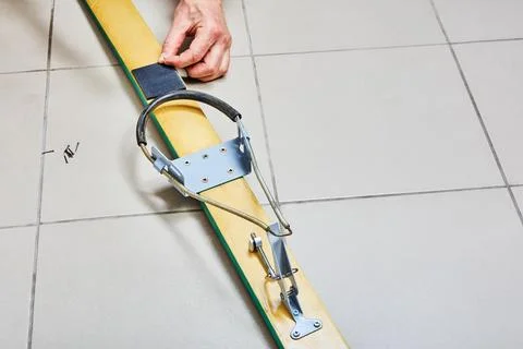 Using nails to secure heel pad when installing cable ski bindings with free.. Stock Photos