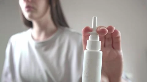 Using nasal spray, decongestants, and antihistamines for flu symptom relief. Stock Footage 285624737