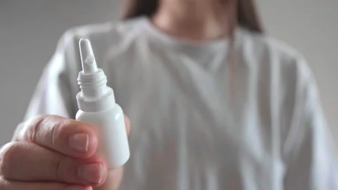 Using nasal spray, decongestants, and antihistamines for flu symptom relief. Stock Footage 285624780