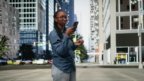 Using navigation app on smartphone, black woman walking around the city Stock Footage 334169149
