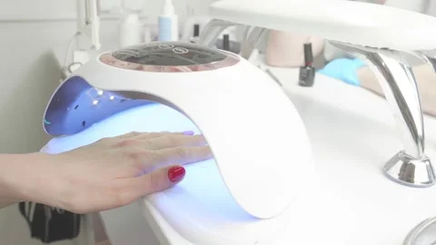 Using a neon lamp to cure gel polish Stock Footage 195738523