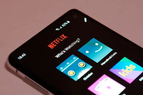 Using netflix app on smartphone Stock Photos