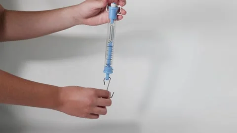 Using a Newton Spring Scale Stock Footage 275579174