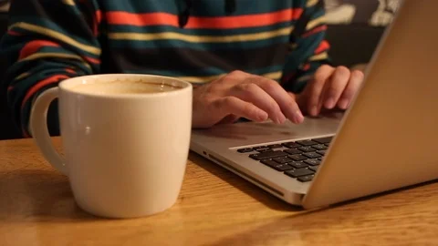 Using notebook with coffee Stock Footage