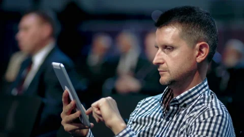 Using notepad conference auditorium crowd viewer. Business men type finger pad. Stock Footage 139313378