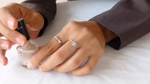 Using nude color nail polish on a white table Stock Footage 145562844