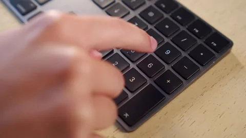 Using a numeric keyboard for calculation. Person calculating numbers on a k.. Stock Footage 340958866