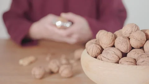 Using a nutcracker to crack a walnut Stock Footage 327354640
