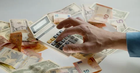 Using old calculator to count money Stock Footage 131329626