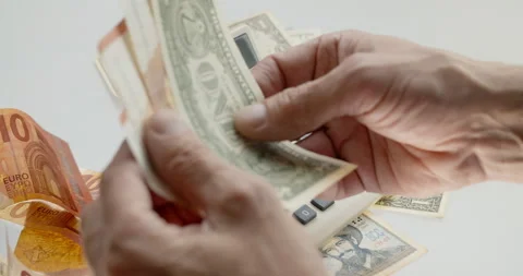 Using old calculator to count money. Holding paper currency Stock Footage 133252253