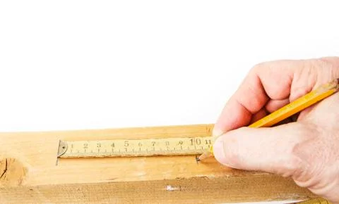 Using old yellow folding meter to measure wood to cut Stock Photos