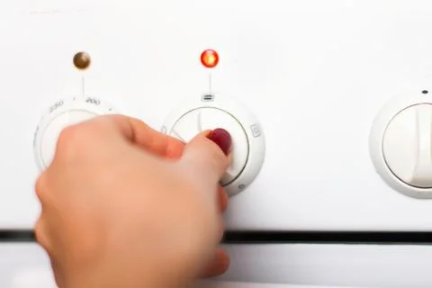 Using an oven, controlling the temperature of the oven. Stock Photos