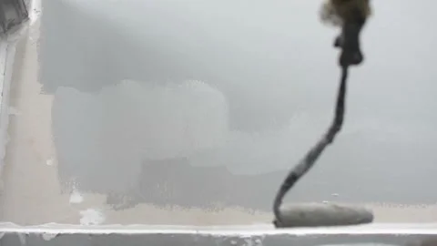 Using paint roller for paint building wall Stock Footage 137818389