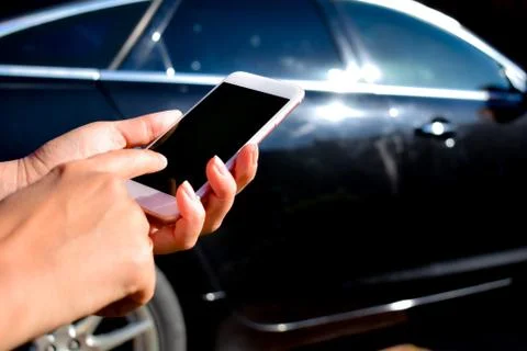 Using the phone in the car. New technologies and car. Stock Photos