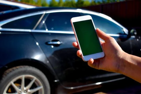 Using the phone in the car. New technologies and car. Stock Photos