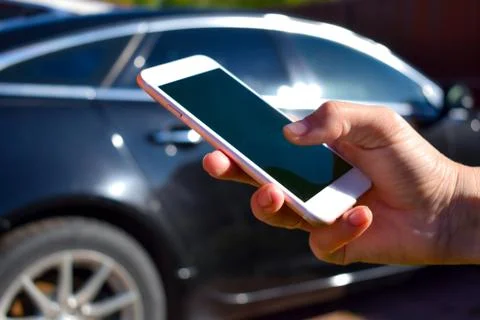 Using the phone in the car. New technologies and car. Stock Photos