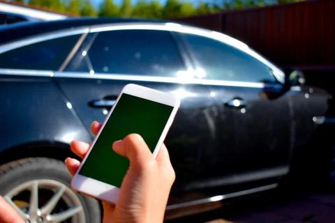 Using the phone in the car. New technologies and car. Stock Photos