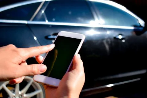 Using the phone in the car. New technologies and car. Stock Photos