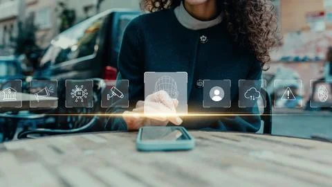 Using phone with deep fake technology on table in urban setting Stock Photos