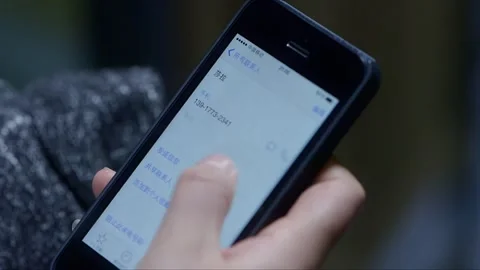 Using the phone to dial a contact's number Stock Footage 261642080