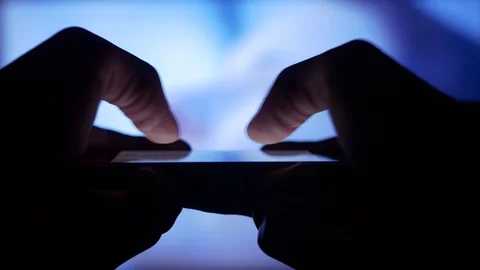 Using phone at home, text messaging while watching TV Stock Footage 101977339