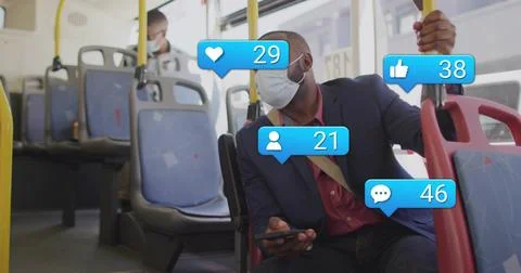 Using phone, man in blazer gripping yellow pole, scrolling on bus with social Stock Photos