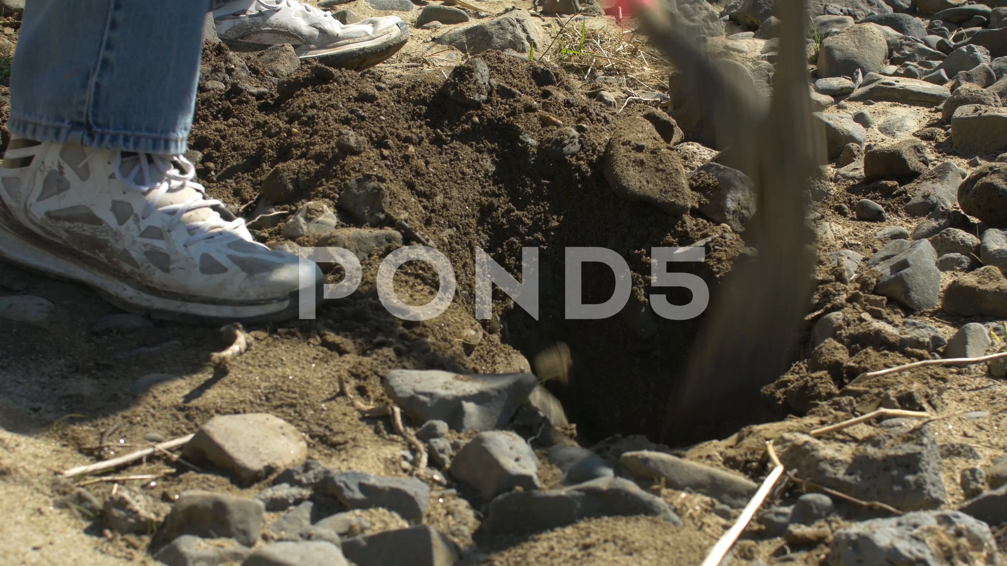 Using A Xe To Remove Rocks In Dirt Footage 77077903