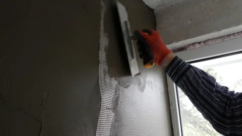 Using of plastic grid for plaster of walls Stock Footage 104417495