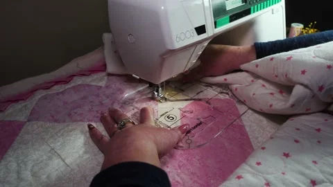 Using a plastic template fitted on a sewing machine to stitch a pattern Stock Footage 168421142