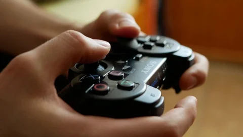 Using a PlayStation 3 controller dualshock 3 Stock Footage 107267646