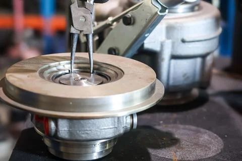 Using Pliers on Turbocharger Component During Repair. Stock Photos