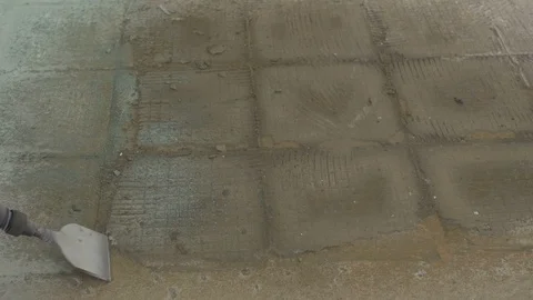 Using a pneumatic chisel to remove flooring on a house remodel Stock Footage 105625693