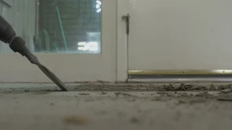 Using a pneumatic chisel to remove old flooring on a home remodel Видео 106133100