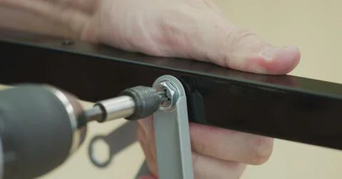 Using power drill screwdriver tool to connect metal parts together, DIY or do it Fotos Stock