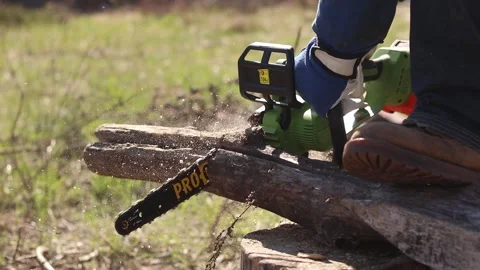 Using a Procraft cordless chainsaw for sawing wood Stock Footage 332945834