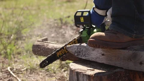 Using a Procraft cordless chainsaw for sawing wood Stock Footage 332945835