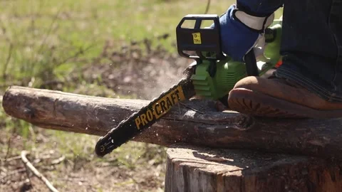 Using a Procraft cordless chainsaw for sawing wood Stock Footage 332945852